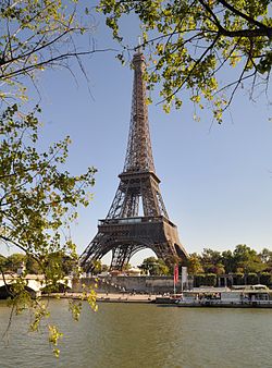 The Eiffel Tower in the day, behind some scenic shot.